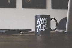 coffee cup labeled hustle